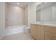 Bright, neutral bathroom with tiled shower, large tub, and natural wood vanity at 2425 Peachtree Ne Rd # 903, Atlanta, GA 30305