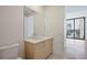 Modern bathroom featuring a wooden vanity, quartz countertop, and large window view at 2425 Peachtree Ne Rd # 903, Atlanta, GA 30305