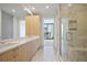 Bright bathroom showcasing double sinks, quartz counters, and a glass-enclosed shower at 2425 Peachtree Ne Rd # 903, Atlanta, GA 30305