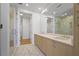 Modern bathroom with double sinks, marble floors, and a glass-enclosed shower at 2425 Peachtree Ne Rd # 903, Atlanta, GA 30305