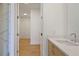 Modern bathroom with wooden vanity and quartz countertop and marble shower view at 2425 Peachtree Ne Rd # 903, Atlanta, GA 30305