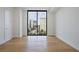 A bright bedroom with hardwood floors and a large window with city views at 2425 Peachtree Ne Rd # 903, Atlanta, GA 30305