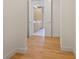 Hallway with hardwood floors leading to a modern bathroom with marble tile at 2425 Peachtree Ne Rd # 903, Atlanta, GA 30305