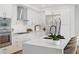 Modern kitchen featuring stainless steel appliances, an island with chairs, and sleek white cabinets at 2425 Peachtree Ne Rd # 903, Atlanta, GA 30305