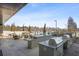 Outdoor kitchen featuring stainless steel grills, counter space, and a dining area with views of the community pool at 2425 Peachtree Ne Rd # 903, Atlanta, GA 30305