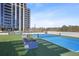 Outdoor tennis court adjacent to a modern high-rise building, surrounded by landscaping and greenery at 2425 Peachtree Ne Rd # 903, Atlanta, GA 30305