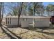 View of backyard with a covered patio, brick accent wall, and a large backyard at 3699 Narron Sw Dr, Atlanta, GA 30331