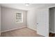 Cozy bedroom with neutral walls, carpet flooring, and a window view of greenery at 3699 Narron Sw Dr, Atlanta, GA 30331