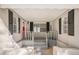 Covered front porch with red door, black shutters, and a cozy entrance at 3699 Narron Sw Dr, Atlanta, GA 30331