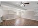 Bright living room featuring hardwood floors, a ceiling fan, and a painted brick fireplace at 3699 Narron Sw Dr, Atlanta, GA 30331