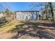 Expansive backyard view featuring a house with a gray exterior, set against a backdrop of trees at 1662 Flintwood Se Dr, Atlanta, GA 30316
