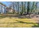 Landscaped backyard showcasing a mix of green grass, trees, and part of a home's exterior at 1662 Flintwood Se Dr, Atlanta, GA 30316