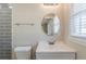 This bathroom features gray tiling, modern fixtures, and natural light at 1662 Flintwood Se Dr, Atlanta, GA 30316