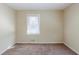 An inviting bedroom features a bright window, neutral walls, and plush carpet at 1662 Flintwood Se Dr, Atlanta, GA 30316