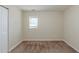 Neutral bedroom featuring a window with blinds, carpeted floors, and a simple, clean design at 1662 Flintwood Se Dr, Atlanta, GA 30316