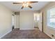 This bedroom has carpet flooring, a ceiling fan, and a bathroom at 1662 Flintwood Se Dr, Atlanta, GA 30316