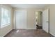 A bedroom with an open closet with bi-fold doors and large window at 1662 Flintwood Se Dr, Atlanta, GA 30316