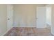 This bedroom features neutral walls, plush carpeting, and an open doorway at 1662 Flintwood Se Dr, Atlanta, GA 30316