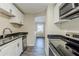 Kitchen featuring stainless steel appliances, white cabinets, and dark countertops at 1662 Flintwood Se Dr, Atlanta, GA 30316
