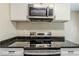 Close-up of the kitchen's electric range and stainless steel microwave at 1662 Flintwood Se Dr, Atlanta, GA 30316