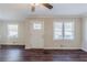 Living room featuring wood-look flooring, two windows and a white front door at 1662 Flintwood Se Dr, Atlanta, GA 30316