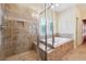 Bathroom featuring tiled walk-in shower and soaking tub with privacy window at 33 Hardpan Aly, Marietta, GA 30066