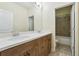Bathroom with double sink vanity and doorway leading to tiled shower and tub at 33 Hardpan Aly, Marietta, GA 30066