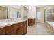 Bathroom featuring double vanities, a soaking tub, and a glass-enclosed shower at 33 Hardpan Aly, Marietta, GA 30066