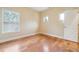 Bedroom featuring hardwood floors, multiple windows, and a neutral color palette at 33 Hardpan Aly, Marietta, GA 30066