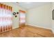 Bedroom with hardwood floors and decorative curtains, ready for customization at 33 Hardpan Aly, Marietta, GA 30066