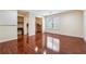 Bonus room with shiny wood floors, neutral paint and a window with blinds for natural light at 33 Hardpan Aly, Marietta, GA 30066