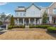 Charming two-story home with light blue siding, inviting front porch, and well-manicured landscaping at 33 Hardpan Aly, Marietta, GA 30066