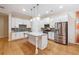 Modern kitchen with stainless steel appliances, granite countertops, kitchen island, and hardwood floors at 33 Hardpan Aly, Marietta, GA 30066
