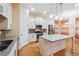 Bright kitchen featuring a kitchen island, stainless steel appliances, granite counters, and hardwood floors at 33 Hardpan Aly, Marietta, GA 30066