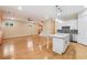 Open-concept living room with hardwood floors, island, and modern kitchen with stainless steel appliances at 33 Hardpan Aly, Marietta, GA 30066