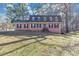 Charming brick home with classic black shutters and lush green lawn, perfect for Gathering living at 4332 N Hickory Ln, Douglasville, GA 30134