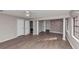 Large living room area featuring wood flooring, stone wall, and bright windows at 4332 N Hickory Ln, Douglasville, GA 30134