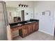 A bathroom showcasing a sleek black countertop and a bright, illuminated mirror at 4520 Mossey Dr, Lithonia, GA 30038