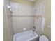 Bathroom featuring tiled walls, and standard tub at 4520 Mossey Dr, Lithonia, GA 30038