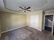 Bright bedroom with carpet, ceiling fan, and closet at 4520 Mossey Dr, Lithonia, GA 30038