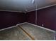 Maroon bedroom featuring trim and carpet at 4520 Mossey Dr, Lithonia, GA 30038
