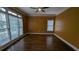 Bedroom featuring hardwood floors, ceiling fan and lots of windows at 4520 Mossey Dr, Lithonia, GA 30038