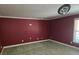 Maroon bedroom featuring trim and carpet at 4520 Mossey Dr, Lithonia, GA 30038
