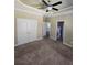 A neutral bedroom with a ceiling fan and en suite bathroom and laundry room at 4520 Mossey Dr, Lithonia, GA 30038