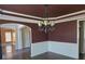 Elegant dining room with hardwood floors, detailed trim, and chandelier at 4520 Mossey Dr, Lithonia, GA 30038