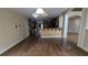 Open kitchen design showing dark hardwood flooring and bar top seating at 4520 Mossey Dr, Lithonia, GA 30038