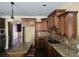 Spacious kitchen with granite countertops, a central island, and wood cabinets at 4520 Mossey Dr, Lithonia, GA 30038
