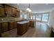 Spacious kitchen features an island, granite countertops, custom cabinetry and hardwood flooring at 4520 Mossey Dr, Lithonia, GA 30038