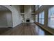 Spacious living room features a fireplace, tall windows, hardwood flooring, and built-in bookshelves at 4520 Mossey Dr, Lithonia, GA 30038