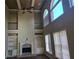 Great room with high ceilings, large windows, a fireplace and built-in shelves at 4520 Mossey Dr, Lithonia, GA 30038